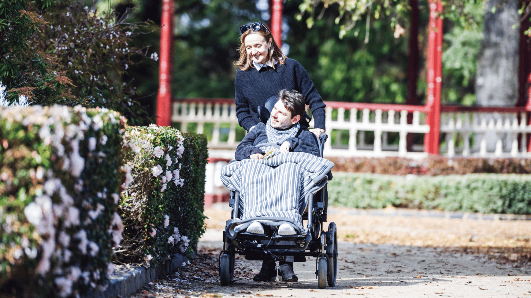 Regal Health support worker walking with a client in a wheelchair