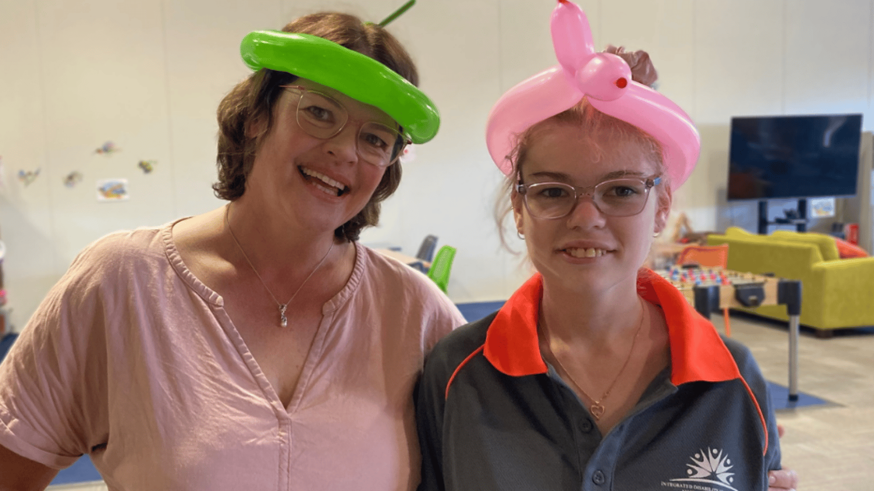 IDSS support worker and a participant smiling at a community hub