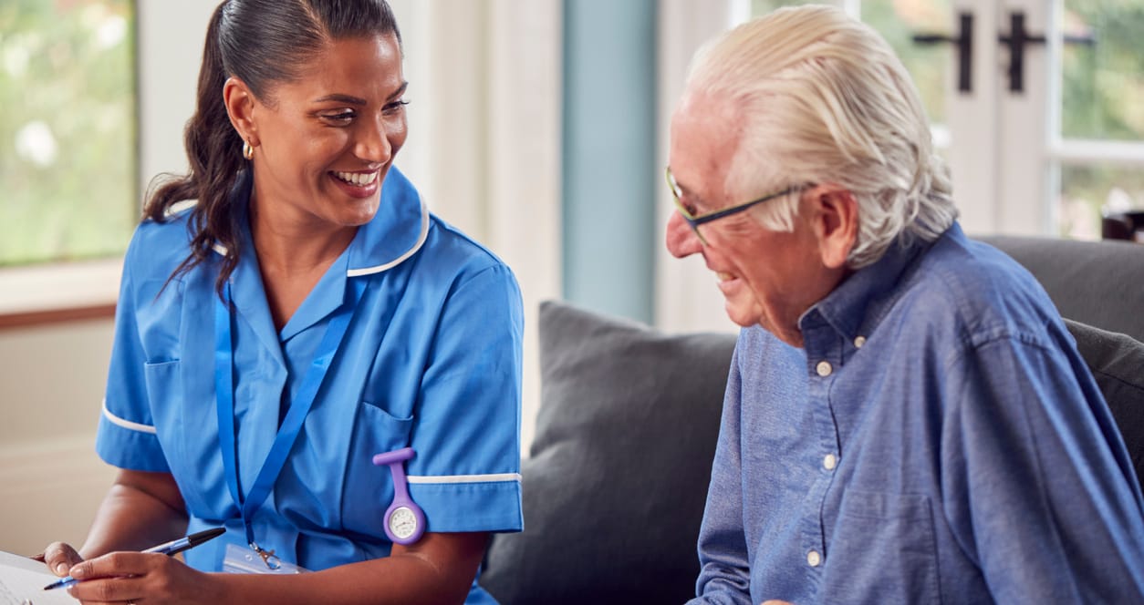 Home care nurse taking notes with an older patient
