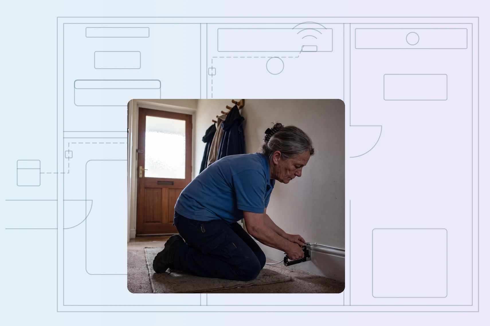Tech clipping cable neatly along skirting run in entry hall