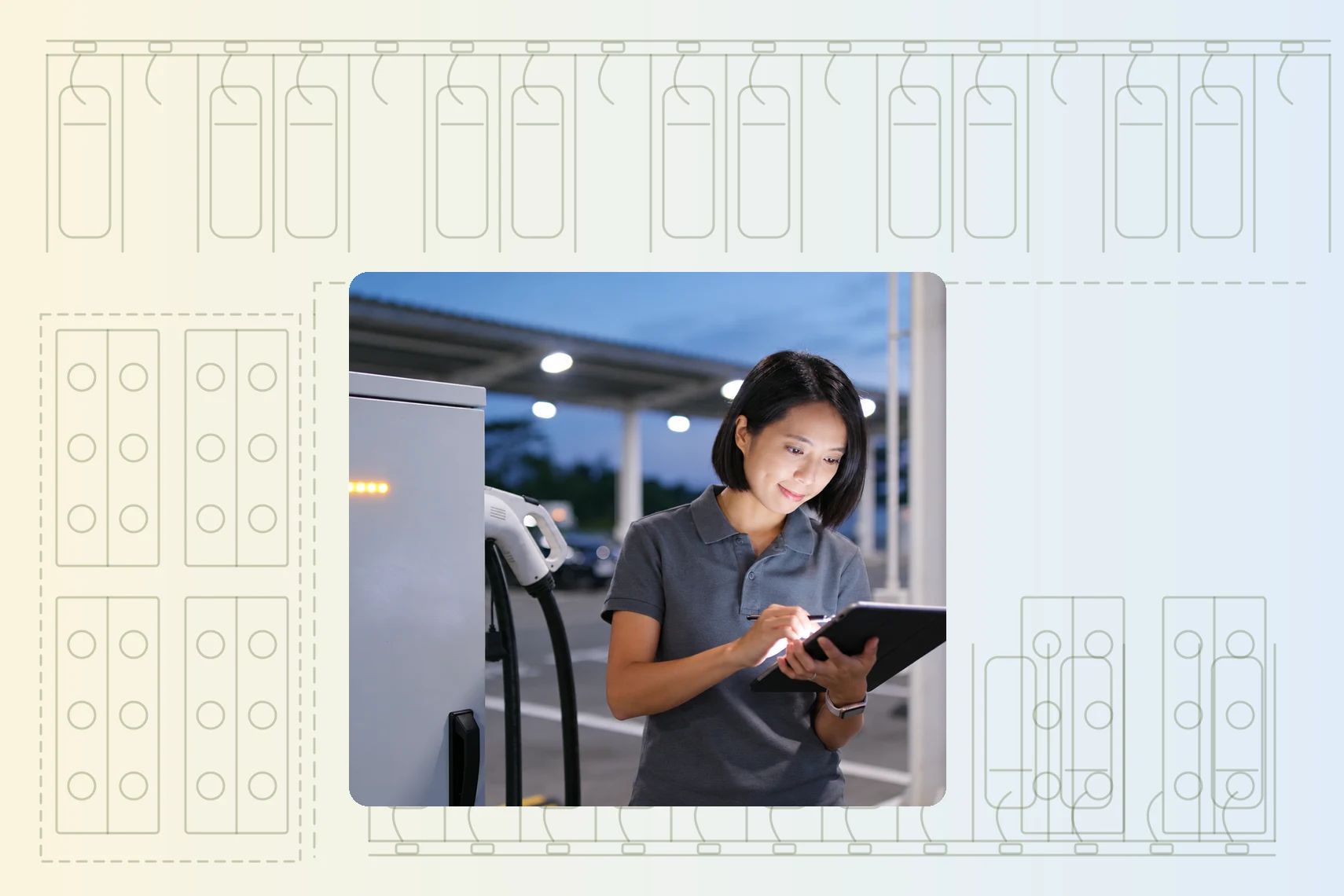 Technician logging a charger check on a tablet at an EV charging site at dusk