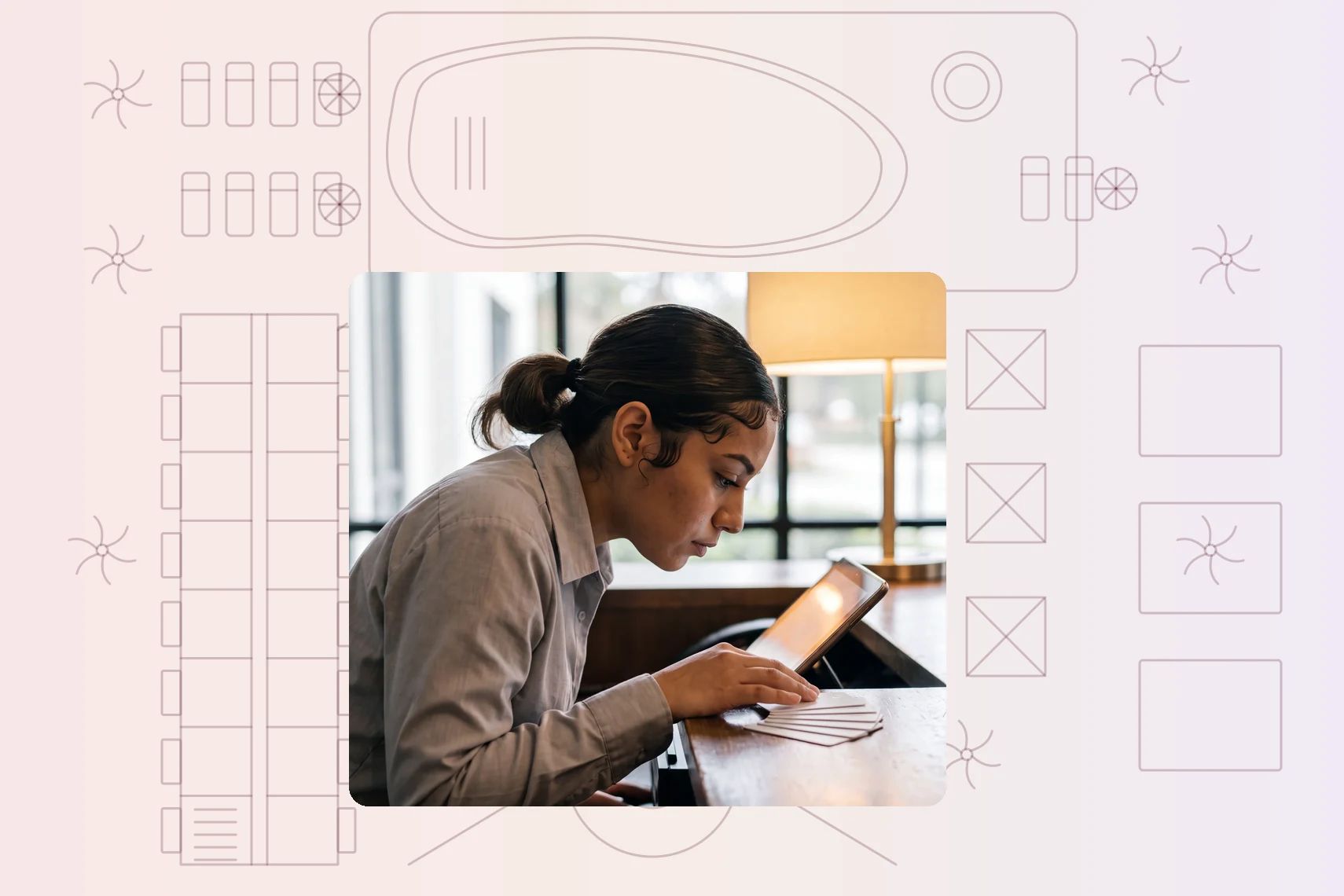 Receptionist checking arrivals on tablet behind front desk