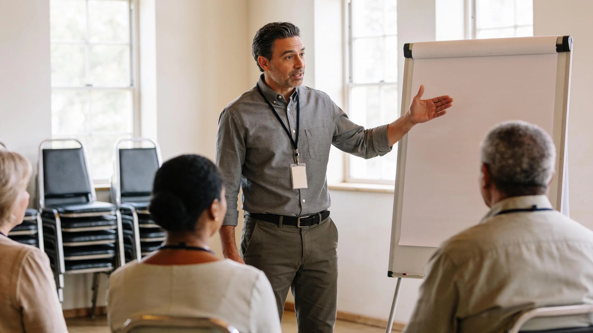 Presenter leading a group session at a blank flip chart