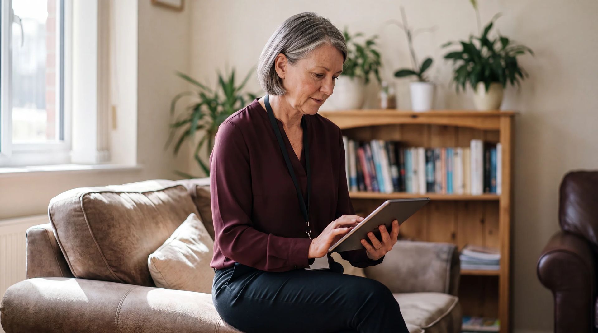 Staff member using a tablet in a residential lounge