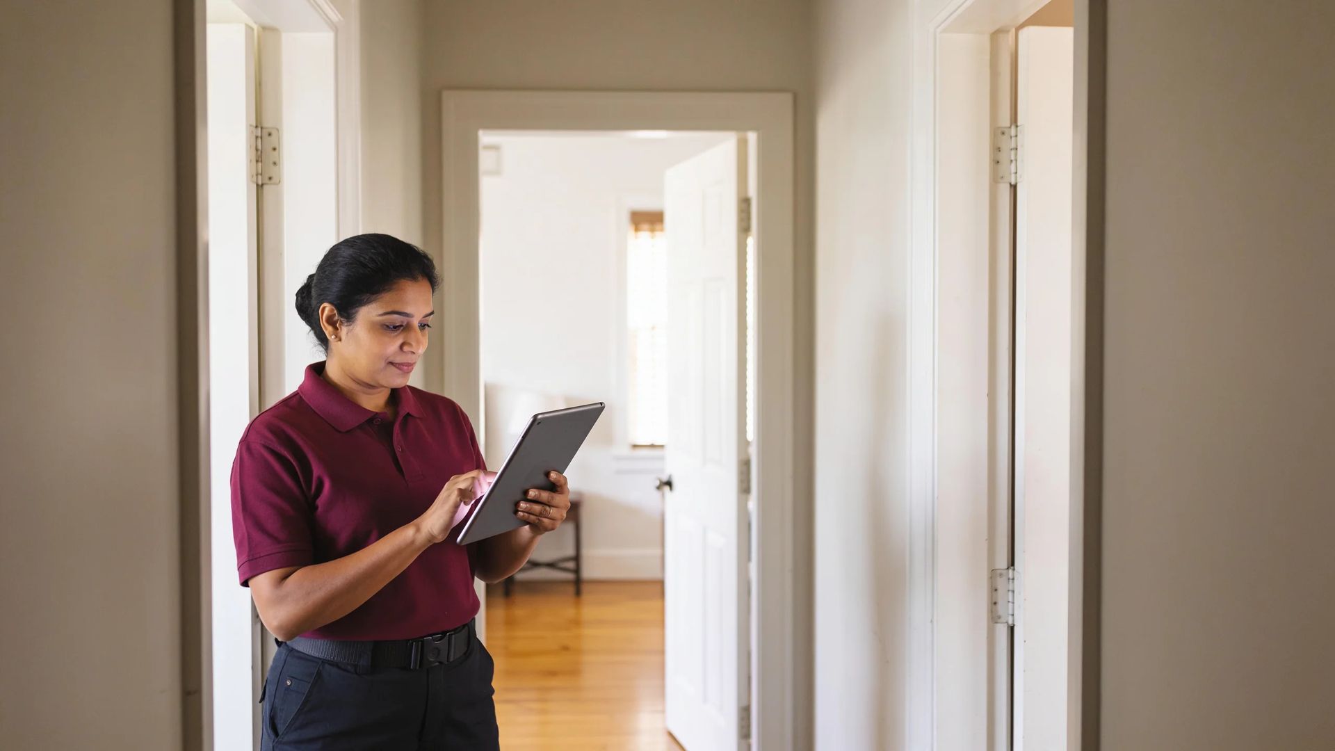 Worker using a tablet in a hallway